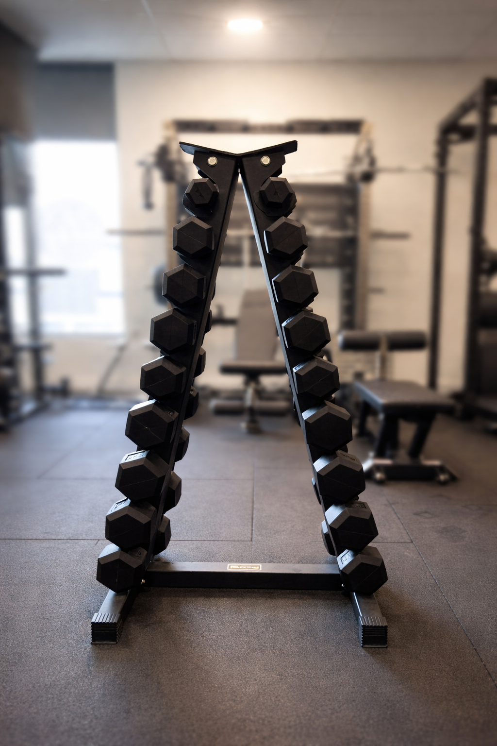 Close-up of rubber-coated hexagonal dumbbell head showing anti-roll design and weight marking.