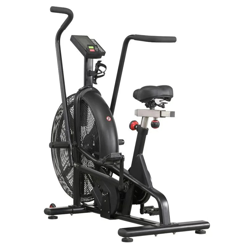 A black indoor exercise bike with a large front fan, digital display screen, padded seat, and adjustable handlebars, shown on a plain white background.