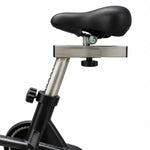 Close-up of a bicycle saddle with a silver metal mounting bar and black seat post on a white background.