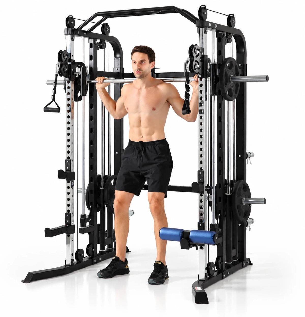 G5S plate loaded smith machine and functional trainer - workout in  large black and silver home gym power rack with a barbell across his shoulders, demonstrating use of the exercise equipment on a white studio background.