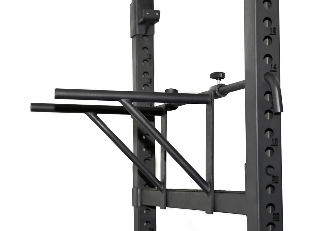 ['Elite Commercial Power Rack front view', 'Power rack with multi-grip pull-up bar', 'Heavy-duty J-hooks and safety bars', 'Adjustable tricep dip station included', 'Full rack setup in home gym environment']