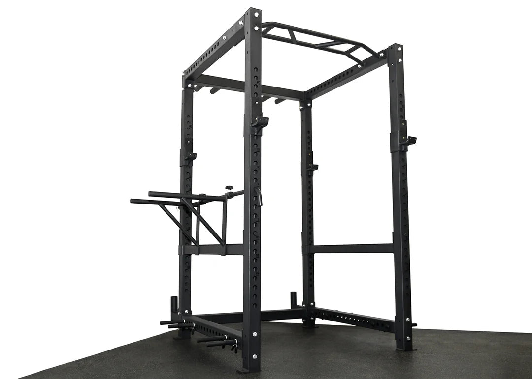 ['Elite Commercial Power Rack front view', 'Power rack with multi-grip pull-up bar', 'Heavy-duty J-hooks and safety bars', 'Adjustable tricep dip station included', 'Full rack setup in home gym environment']