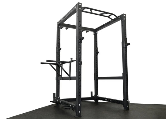 ['Elite Commercial Power Rack front view', 'Power rack with multi-grip pull-up bar', 'Heavy-duty J-hooks and safety bars', 'Adjustable tricep dip station included', 'Full rack setup in home gym environment']