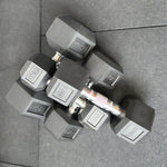 Overhead view of multiple rubber hex dumbbells ranging from 5kg to 42.5kg, showing the 2.5kg weight increments. 24/7 gym equipment